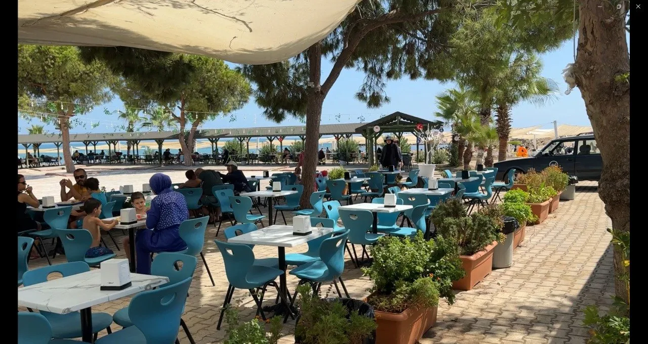 Tables under shade at the café inside Alata beach