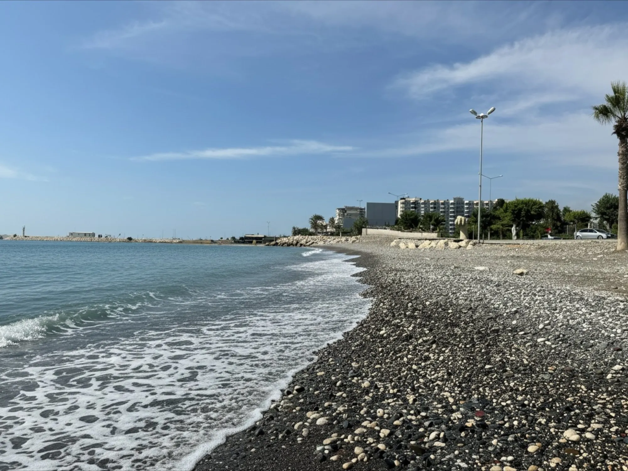 The pebble half of the municipal beach in Erdemli, with clear water and no crowd