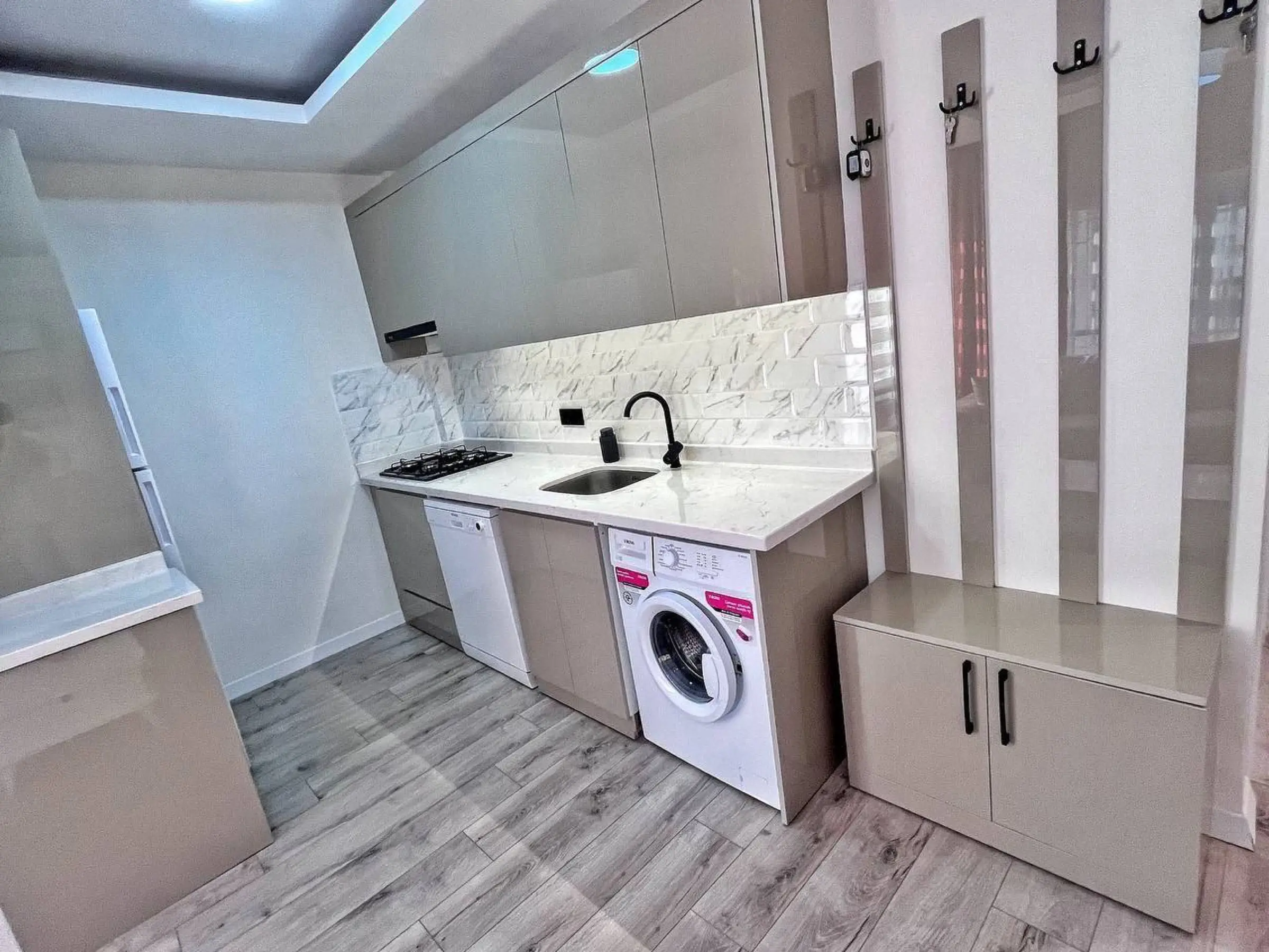 Gas hob, sink and washing machine in the kitchen