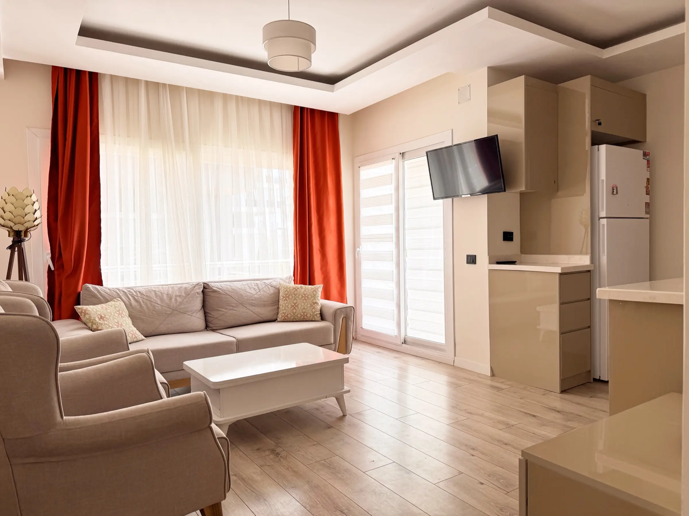The living room of the apartment in Erdemli, with daylight through the balcony doors